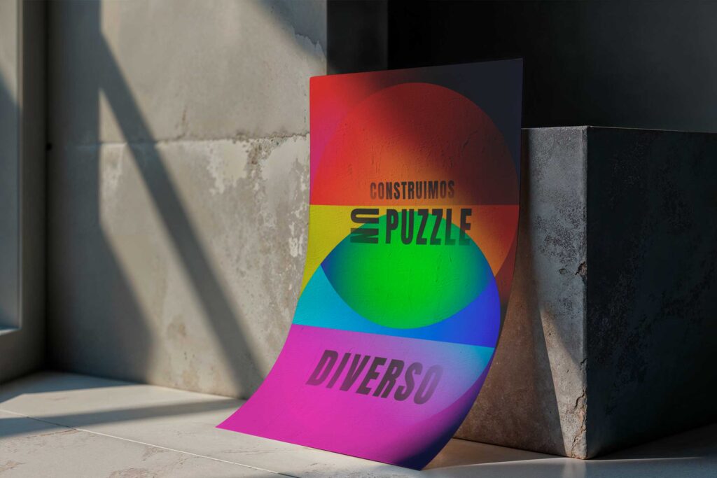 Cartel de campaña con mensaje de diversidad sobre fondo de colores arcoíris, aplicado en superficie urbana.